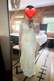 I wore this dress (size 6) to my mountain top elopement. I have a muscular build, so it was on the tighter side, especially in my hips and arms. Still, I hiked up a mountain for about an hour in this! The sleeves don't have a lot of give, so I would just move them up onto my shoulders as needed. There is not much of a train on the gown, which was what I wanted. I had the dress hemmed and added a button for a bustle. It was secure enough that I didn't need to wear a bra.
This is a PERFECT dress if you want something beautiful that's inexpensive. Just make sure you get the right fit and you'll love it. > - Rose H.