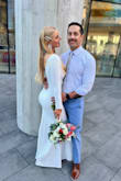I purchased this dress for my courthouse wedding and fell in love with it! It's flattering in all the right places; snug around the waist, hips and booty! The sleeves and length was too long for me, so I had it hemmed. The material is stretchy, so it was comfortable and easy to move. The material is also thick, so there's potential for getting hot on those warm summer weddings. My favorite part of the dress is the buttons down the back. I would definitely recommend this dress! It's sleek, sophisticated, clean, simple, elegant, and can be glammed up with accessories! Plus, you can't beat the price! - Brittney F.