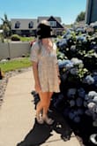 This dress was very pretty! I got lots of compliments on it. The cut is very very very low and would show lots of cleavage (I don't have any to show hahaha) It is also very short. I am shorter so it was a perfect length for me. I ordered a size xs, and it worked great. It was still pretty loose. I am normally a size small. - Samantha J.