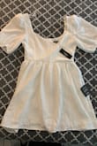 I bought this dress because I love the sleeves and think it is adorable! I wanted to wear this to my graduation, but it is a bit short on me, and I can't really sit in it without it hiking up really high. The fit is perfect, I just wish it were a little longer. - Bianca P.