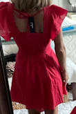 This red dress caught my eye and so happy I put it in the bag and bought! I'm petite frame 5'2", 100 lbs to give reference and ordered XS and fits perfect. I did have padded bra on when I tired on and would not wear as the natural bust line on this dress is better suited without bra or a sheer ...If you're small framed but busty, I would size up 1 size. It's linen material but good quality and has pockets that blend very well into the dress and the ruffled sleeves are a feminine touch. Super happy! - Laura S.