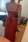 Super cute and nice quality, color was a bit more red than I thought. My main issue was the fit. I'm a 23b and 27 in pants, the top was a bit loose (not wearing a bra in photos, and the skirt fit me well through the hips but the waist was wider than expected so it sat below my belly button which I wasn't stoked about. - Casey N.