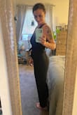This romper is adorable. It's belted at the waist and is very figure flattering. It comes up high enough in the back a regular strapless bra can still be worn. I am 5'8, 140lbs, normally a size 6, and a Medium fit very well. It is a little big on top (I am 34C) but nothing I can't work with! - Rachel M.