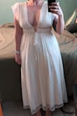 I ordered this for my elopement and it's very pretty! I'm between M and L, but after reading reviews, sized down to M and am glad I did. The shoulders are soooooo roomy despite usually filling out a dress with DDs. It's also pretty long for a midi (even with heels). Given how much the shoulders and length need to altered along with the delicate overlay, alterations ended up being about 3x more than what I bought the dress for, but it's still more affordable than an actual wedding dress and I definitely don't regret it! 

P.S. You'll also want some boob tape and double-sided fashion tape to hold everything in place! - Lauren L.