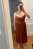 I went by [the] sizing chart & measurement recommendations and ordered a medium. I usually go up a size if it's going to sit on my hip, but I have a very small chest so thought being on the higher end of size recommendations would be fine. But she's TIGHT.  I'm pretty disappointed with the way it fits my chest. It's awkwardly very low in a way that doesn't seem like it's intended. I'm unsure if it's supposed to fit high on my rib cage or hit directly at my waist. The colour and pattern are nice, material is similar to what you'd find through comparable retailers. - Sarah T.