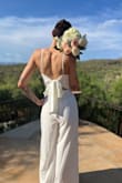 I loved everything about this jumpsuit!! It's fitted on the waist and loosely fitted waist down. It has a flowy touch to it that makes it more sophisticated & gives it a dress appearance. I wanted something lightweight for a July Elopement & this was everything I had envisioned for an intimate ceremony. It made me smile when I tried it on so I knew it was the right pick. - Isabel A.