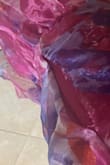 The dress has two layers. The inner layer is bright pink and stretchy. The outer layer was not stretchy at all, and plasticy. It was too long for me, but seemed okay until I tried to put on my shoes and the seam ripped almost 6 inches along the hip. The fabric shredded so I couldn't get it repaired. It was disappointing. It hadn't seemed tight but tore like piece of paper. I was going to wear it for a wedding, but had to find something else. The bride had picked this out and was NOT happy. So, if you buy it, be careful! Don't bend over. (And you probably want to be taller than 5'2".) - Jacquelyn S.