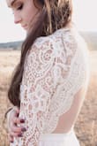 This dress is stunning! I am a photographer and purchased this dress for a styled session and the model totally rocked it. The scalloped lace detailing on the back is to die for, the material is high quality, and the neckline is very flattering. When I was planning this styled bridal session I knew what kind of dress I wanted. I looked literally everywhere for what I wanted but no luck, and when I found this dress it exceeded every expectation! This dress would be gorgeous for a wedding and it would look like it cost you an arm and a leg! - Bailee W.