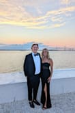 The small was a little snug and I returned it for the Medium which was absolutely perfect. I had to hem it as I'm quite short. I wore it for a black tie wedding and felt beautiful in it. Lots of compliments. A non-boring black dress with class. - Chelsea D.