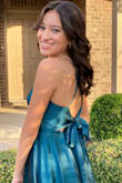 I wore this to my HOCO dance. The color is more teal than emerald green but that didn't bother me. The fabric is shiny but comfortable. I did have to knot the tie back to keep it from coming undone but overall, I loved the dress and I am happy with my purchase. - Tania A.