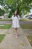 This dress is so cute and fun! The part that goes around my boobs does feel a little loose, but if I had done a size down I think it would have been a bit too tight. But I am very pleased with this purchase! I apologize that one of the photos is blurry! - Ann M.