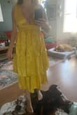This dress is very cute, it is textured and has a nice feel. The dress fits perfectly, especially in the bust, but the very top of the zipper in the back does get a little tight, but if I sized up the dress would for sure be too big. - Cassidy M.