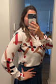 Great fit. I usually wear L but it depends on blouse/short style. I ordered M and it feats perfect on bust, length and arms. The textile is light, and the buttons do not open on my bust area!!! Definitely recommend. - Jackie B.