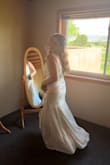 This was my wedding dress, and I got so so many compliments on how beautiful it was! The pictures do not do it justice. I should've sized down to a large but got it altered instead. The top can get taken in quite a bit without making the armpits too tight. Would recommend it to any bride! - Erica Z.
