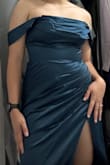 I bought this to wear at my Fiancés military ball. I wanted it to be snug and getting the M was definitely form fitting. The color looks more of a blue to me. Please don't hesitate on it but the slit is a bit high - Mia R.