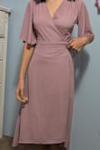 It's a dress you can easily wrap around your body, making it incredibly adjustable and flowy. I like to fly in blind, so it's lovely they have a feature to help with that. I ended up buying a small and I love it! It flatters my shape while keeping me classy!! - Thea W.