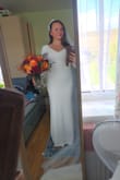 This dress is simply beautiful and classic. It's made of a beautiful material which is really comfy. I will need to have the sleeves, arms and length altered, but other than that, it's perfect. Really happy with my purchase. I have added a pearl belt to it to cover the little line. - Karolina