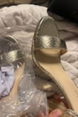 Here is a photo of a little damage to the shoe when I received it. It needs more glue. Also, no one's toes are that narrow to fit inside the strap & ouch. - Sierra K.