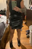 I'm definitely in between sizes. I'm 5'0, a muscular 124 lbs, hips 38". I think my waist is like 28", and I'm usually an xs to an s depending on the material. I ordered a small, pictured, and it was just weird on me. Too long for my taste, very baggy across the front yet still fitted on my butt. I exchanged it for an xs, also pictured, and I can barely zip it. It has to sit very high on me to get into it. The zippers were very stubborn on both skirts. I love how it looks and the little slit and it seems like nice quality, but I think it's built for nonathletic girls. I overall love it, just wish the sizing wasn't weird - Katherine W.