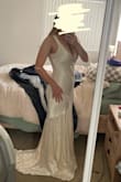 I ordered this for my wedding/elopement ceremony, and it is just as shown in the images! Very heavy material, and the dress has a liner underneath the main satin. Still pretty see-through, even with the liner. Dress is a little short in the front, so when I wear heels with it my toes barely peek out from the front- something to keep in mind! The color appears more yellowy in my photos, but in person, it definitely looks more like an off-white/ivory color. Definitely a more low-cut top, but when I tried it without a bra, it worked perfectly and didn't make me feel like I was showing too much. Overall great quality, and a beautiful train! - Mary M.