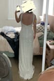 I ordered this as a "back-up" option to the dress I was originally wanting; I wanted something satin, timeless, and no sparkle- but this dress caught my eye and I had to see how it would look. I fell in love! I am normally a small, but decided to order a medium just in case. The medium fit me perfectly, like a small normally would, but the straps are a little loose/big. I selected that the fit is a little small because I feel like a size small would have worked for me, but probably would have been a little too tight, and I was going for a more loose/flowy fit. The dress is VERY long, even in heels I was tripping over the front. The train is just a little longer in-person that shown on the model, which I love. Heavy material as well! Still a little see-through even with the liner. I was really worried that all the beading on the dress would look cheap in-person, but it is really well done and looks like some $2,000-3,000 dresses I've seen from other bridal designers. - Mary M.