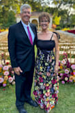 The bride requested "colorful garden black-tie attire". This dress was perfect for my 63 year old body. I usually wear a small or medium size top and size 8 bottom. This is a size large dress. I am 5'9 and wore 2" heels. It touched the ground a slight bit. I had to add material across the top because I'm a 36D and I didn't want my cleavage crack showing. You can see this same thing on the model. If you're smaller than 36D, it would be perfect. The top was stretchy, like fishnet pantyhose. I wish it had more structure/form for hold on the sides under the arms. The top is stretchy, and the skirt is not. It's a more substantial and firm fabric. The skirt had beautiful 3 dimensional flowers. I absolutely loved wearing this dress! The zipper was broken, but customer serve took care of it immediately. They were easy to contact and very nice. - Linda E.
