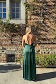 Stunning wedding guest dress in a fabulous green colour. It fit the colour palette of the autumn wedding perfectly! 

The length was slightly too long for me but worked with high heels. And it's not uncommon for me to get dresses altered (shortened) with my 5' 4". I did have to add a button so the slit wouldn't be too high and I could dance all night without being worried. - Linn V.