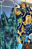 I fell in love with the colors and style of this dress. I ordered a size small which fits perfectly.  I will have to hem it a bit but more because I don't plan on wearing heels or maybe not any shoes at all since the wedding will be on the beach. The material is soft and feels expensive. There isn't any give so the top part is a little tight but still ok. It flows over my hips but fits at the waist which is flattering. Perfect for my beach renewal. - Jennifer R.