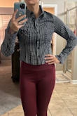 This is a very cute shirt and it does look like the one pictured in the photos. The thing is that it is a tight fit, the light fabric does not have any give, and I would highly recommend sizing up; also be aware that it is more of a cropped fit, so if you want this for work, you're likely gonna have to wear high waisted pants with it, but it will look really good if you have a lean hourglass figure. It looks good on me and I'll be keeping it, but I have a lean athletic hourglass build with a smaller chest, so take that into account as well. - Carley J.