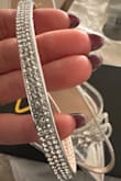 The "diamonds" around the straps are stickers. They look cheap and will most likely come off once you try to put them on and take them off a few times. Not sturdy to walk in, the heel is a flimsy plastic. Sad I have to pay the shipping to return them. Not worth the price or shipping. - Lisa C.