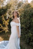 I bought this dress on a whim before my elopement. This dress was so beautiful on! It matched perfectly for my summer wedding was stretchy enough where it was fitted but I could move comfortably! The train is the best part and makes the dress look like it should have cost a couple hundred dollars. I can't recommend this dress enough! - Macy W.
