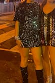 This is so cute! I wore to the eras tour and it was so so perfect for a midnights vibe. The dress is very short, so shorts under are a must (I'm 5'9 so I am tall), but I wouldn't size up unless you want it to be baggier overall. The sequins are super soft, and don't shed. There are little shoulder pads but nothing that should stop you from buying. - Kelly M.