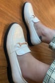 I looooove these shoes!! It's a good mix between a ballet flat and loafer. I bought my regular size and they fit good, they're snug so no concerns with them falling off. I'm still able to put a light pair of socks with them. If you're looking to wear with thicker socks, you should size up. I'm currently wearing them with Lulus Modish Behavior Cream and Green Plaid Corduroy High-Rise Pants. It's a perfect paring option with a white sweater. The white shoe is also so beautiful, goes with everything and is more unique. - Carolyn C.