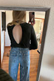 I absolutely love the open back on anything I own. It gives it that tiny hint of sexy, while still being conservative I would say. Personally, I would say runs a touch small; it felt like an XS to me but maybe that's just how crop tops are. The back seemed more open in the picture I took, just since I reached my arm back around to take the picture. The dark green is such a great color and the sweater was a thick material which is awesome since I'll be wearing it in the Fall/Winter/Spring months. Whenever I have a picture in my head of an outfit I am looking for, I know I can find it on Lulus so no surprise I found this sweater after having an idea in my head. - Katie S.