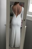 I've been looking for a dress for my town hall wedding before my destination wedding in the (chilly) northeast.  This fabric is very nice, has some give to it, but you can definitely see outlines of everything (panties, stickies, your dinner, etc).  It's just the nature of the bodycon style.  The shoulders stayed on well, though I have broad shoulders so I'm sure that helped.  I don't LOVE the dress, but I'm considering wearing it still as it's rather warm and would work well for a chilly April day. I really haven't found much else. - Melissa G.