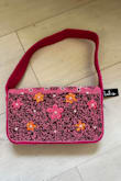 It's still a nice bag, but the colors are nowhere near what is shown in the photos. The bag is more magenta with bolder colors compared to the more muted colors in the clearly edited listing photo. - Tammy B.