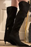 I am a 6, but ordered a 6.5 based on reviews saying the boots ran small. I bought these on sale for like $15 meaning they were final sale with no exchanges, so I figured it was safer to size up a little than be unable to fit them at all. I disagree with reviewers who found this shoe too small, as a 6.5 is roomy on me (no big deal, for $15 I will just wear thick socks). However, the top of the boot that goes over the knee is crazy wide. I am a very skinny person with equally skinny legs, so that's just my perspective. I bought these to wear under long skirts for office wear, so it doesn't bother me that much because it can't be seen. I LOVE how these boots look, though I feel the pointy toe elongates the boot where, coupled with being a half size bigger than I normally wear, the boot looks a little bit like a clown shoe that is too long for my foot. Again, for $15 I'll just deal with it, but if I were to order in another color, I would order my normal size. - Emily K.