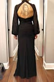 I love this style of dress, and it fits me perfectly even with my height, short torso, and small chest. The fabric is thick and the structure is flattering. It's very fitted in the waist and hips but doesn't accentuate problem areas. I have a lot of lumps and bumps in my midsection due to multiple surgeries and almost always wear shapewear but wouldn't need or want to with this. My issue was with the quality of the construction in certain areas. Directly out of the package, the edges of the slit had numerous frayed/loose strings. With a brand new dress, that wasn't on sale, I didn't want to risk cutting them down and the seams eventually coming undone. So sad because it's a gorgeous dress - Tiffany B.