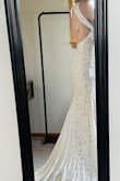 The photos dont do it justice, but I havent gotten married yet, so I dont have great pics. I wouldnt say the dress runs small, but it fits tight. It is absolutely stunning on, though! The neck is a little loose, so I plan on altering that myself, and I also want to sew the nude lining to the lace so it doesnt separate, as you can see in this photo. Less than $40 for a beautiful dress that only needs a couple of alterations I can easily do on my own is soooo worth it! Would definitely recommend! - Angela T.