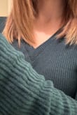 I like the deep forest green shade of this top. It feels more like a top than a sweater. It does not feel soft like a blanket (it's not scratchy or rough, it's just not a plush cozy kind of knit). I think it looks cutest with the V pointed as far down as possible. When the V falls too high, the neckline isn't as flattering (on me, anyway) as it is with a low drop. I will probably always tuck it up into my jeans for a more crop fitted hem - the natural hem line is quite long and curved. The arms are the tiniest bit tight around my shoulders but I wouldn't change sizing. I ordered my typical size. Also, the ribbing isn't very obvious in the model photos but it's very obvious in person. It's definitely a rib knit. Again, the color's really pretty, especially if you look best in "Autumn" shades. - Katy M.