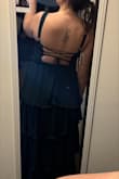 This dress is very cute! My only problem would be that is it a bit loose around the stomach area and gets bunched up. I tried to tie up the back as much as possible and it does decent at tightening it up. Overall, the dress has its quirks, but it is very flattering! - Maddie H.