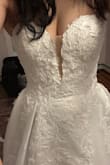 I tried on a lot of lulus dresses, and when I put this one on, I instantly was like wow!! Def need someone else to zip you up cause I really struggled doing it myself, but it fit so perfectly, snug on the top which I thought was great for the corset look- and I got my usual size. Seriously felt like a princess bride. The A-line look with the corset is so flattering and the dress feels expensive. The beading is nice and delicate. I would love this dress if I were to have a wedding but didn't exactly fit for an elopement personally. Wouldn't be a deal breaker, but I didn't rlly love the mesh fabric in between the plunge cut. - Jamie D.