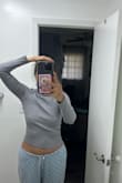 I'm usually a size M, but I decided to order a size L this time. I was surprised to find that the blouse was still short at the waist level. It was unexpected that the blouse runs small even in size L. I can't lift my arms because ended up showing my belly! However, I love turtlenecks, and I really like Lulus. - Tatiana B.