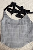 My daughter wanted to wear it with new jeans and she couldn't even tie the straps. They ripped immediately after she put it on. Super cute, unfortunately not what we expected. - Marcela P.