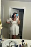 I loved wearing this dress!! I wore it to my graduation and in my grad photos and it was just lovely. I'm a little on the taller side, so with heels, it was barely long enough, but that didn't bother me at all. Also, the criss-cross in the top isn't sewn in place so you need to adjust it to get it to sit where you want. Might need to tack it together if you don't want to show too much cleavage. But it was so cute and I received many compliments! - Jenna K.