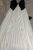 I originally ordered this in a medium, but I had to exchange it for a small because the chest area is very stretchy and looked pretty big on me. I am 34B. The small fits great, but I'm still not a fan of the straps. This dress is pretty long and hard to tailor due to the material. Very pretty though! - Gresia L.