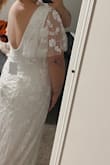 The dress fits perfect! I love the train and the detail. I was able to zip the dress up on my own! I got a size large. - Faith N.