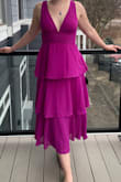 The dress is exactly as pictured! I ordered the purple, please note my camera did not capture the true color of the dress so it looks more pink/red, the true color of the dress is much more like the Lulus images.
The dress runs a little small, I ordered a size medium which I always prefer and I usually have a little bit of extra wiggle room, but this one was a bit more snug than I'm used to, but nothing unmanageable. In the image I am wearing bra pads, the dress does have much coverage at the boobs so if you like a little more just a heads up. The dress is also a little lower cut than I was expecting, I'm not sure why I didn't expect this considering all the photos I looked at before purchasing, but I think it's one of those things where it looks great on other people but on you, it feels more revealing because it's yourself!
Overall, I would definitely recommend the dress, it has modest coverage for the legs/butt, but a little bit more skin up top, which is a great balance and great for a wedding. - Grace A.