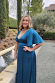 This dress doesn't have stretch, but flowed beautifully and covered my belly that I'm insecure about. It was nice and cool with the slit while dancing at the reception. It was a little too showy on the cleavage, but I had a scarf that helped cover it. It was a perfect dress for the black tie wedding I attended. - Amanda J.