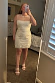 I ordered this dress for my rehearsal dinner. It's really cute on and fits well. I noticed that the top sheer part doesn't have any flowers on it like in the picture. I emailed customer service and they told me the item was defective and sent me a new one. The one they sent me looks exactly like the original one I got. I added pictures of the original dress and the one they sent me. - Kelly K.
